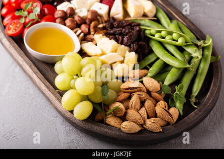 Cheese plate with fresh vegetables and fruits Stock Photo