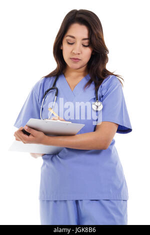 Stock image of female nurse writing on patient chart isolated on white background Stock Photo