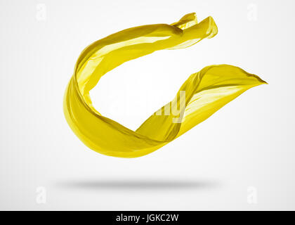 Smooth elegant yellow transparent cloth separated on gray background. Texture of flying fabric. Stock Photo