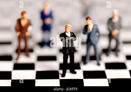businessmen figurines on a chessboard, management and decision making concept Stock Photo