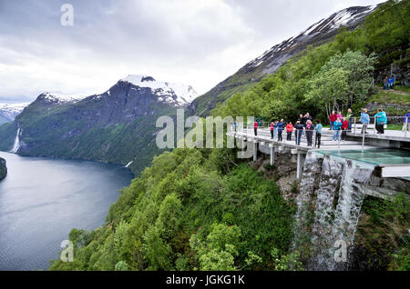 Viewpoint Ornesvingen at the Geirangerfjord with Seven Sisters Waterfall in the background. The fjord is one of Norway's most visited tourist sites. Stock Photo