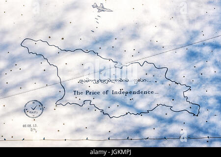 The Price of Independence, painting of on scarred wall with bullet holes left behind by the 2008 conflict, Gori, Georgia Stock Photo