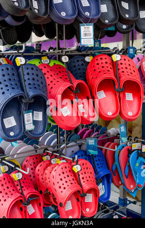 Display of beach footwear for sale in the seaside town of Newquay, Cornwall. UK. Types of plastic. Stock Photo