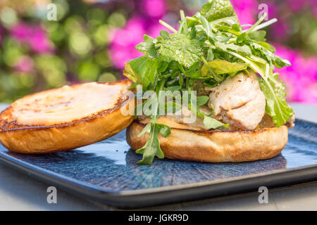 Grilled ahi tuna steak topped with arugula served on a bun Stock Photo