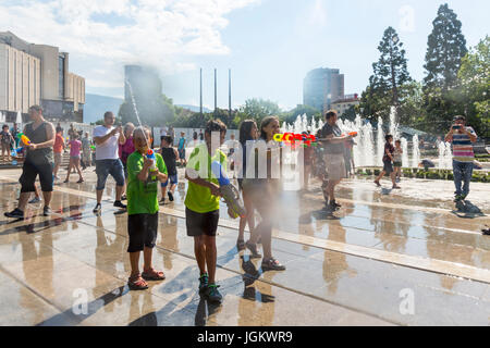 Sofia, Bulgaria - 8 July 2017: Children and adults participate in a fight with water guns and other water spray equipment in the center of Sofia. Stock Photo