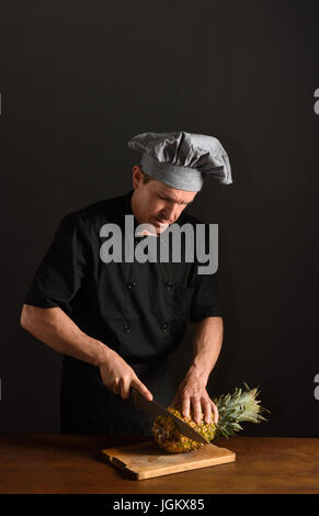 chef cutting a pineapple Stock Photo
