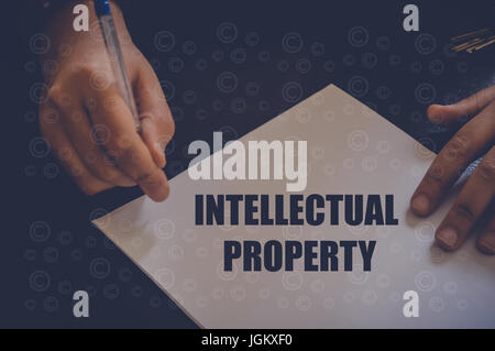 Intellectual property written on white paper by businessman in office Stock Photo