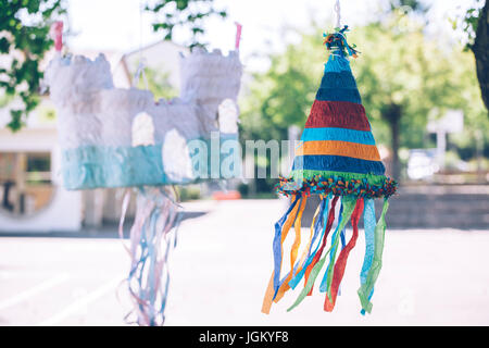 colorful castle and cone shaped pinatas Stock Photo