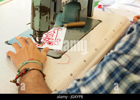 man working with old machine embroidery txtile Stock Photo