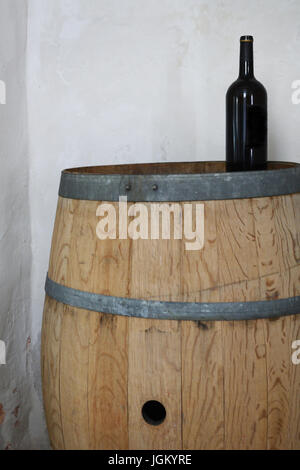 wine bottle on wooden barrel Stock Photo