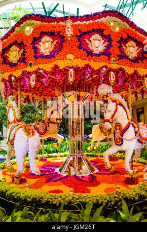 Las Vegas, USA - May 7, 2014: Wynn hotel decorated with rose flowers and carousel with horses inside mall in Nevada Stock Photo