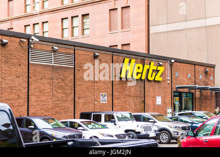 Montreal, Canada - May 26, 2017: Hertz car rental sign and brick building in downtown area of city in Quebec region Stock Photo