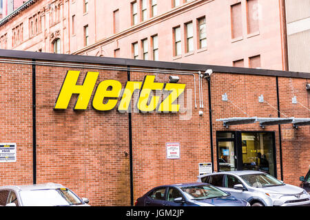 Montreal, Canada - May 26, 2017: Hertz car rental sign and brick building in downtown area of city in Quebec region Stock Photo