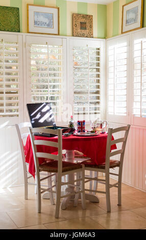 Small dining table with natural lighting. Stock Photo