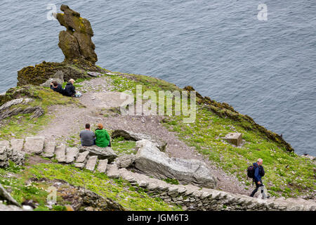 Tourists climbing stone steps on Skellig Michael, County Kerry Ireland Stock Photo