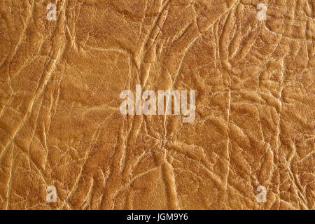 Brown textured leather background. Natural texture close-up. Useful as background for design-works. Stock Photo