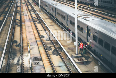 Public transit worker inspecting train in New York City Stock Photo