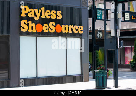 A logo sign outside of a shuttered Payless ShoeSource Inc., retail store in Cincinnati, Ohio on June 29, 2017. Stock Photo