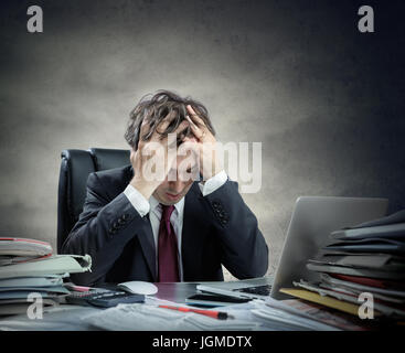 Frustrated Businessman Sitting In Office Stock Photo