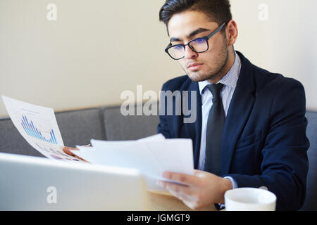 Serious leader reading new contract in office Stock Photo