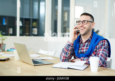 Happy leader or agent speaking on smartphone in office Stock Photo