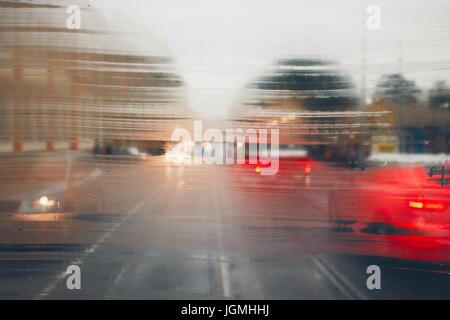 Gloomy day in the city. Street in rain. Selective focus on the raindrops on the window. Prague, Czech Republic. Stock Photo
