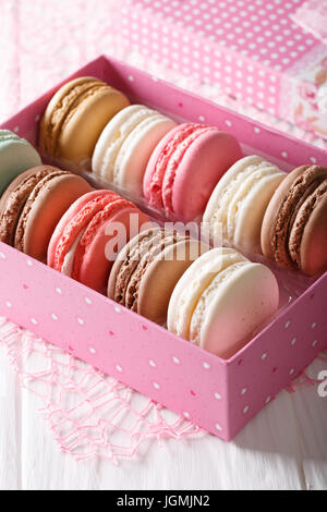 set of macaroons in a pink gift box close-up on a table. Vertical Stock Photo