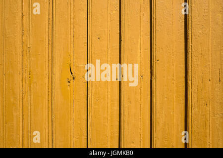 exterior wall of a typical yellow colored Norwegian wooden house Stock Photo