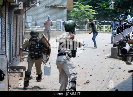 Kashmiri Muslim protestors clash with Indian Forecs during a protest on the first death aniversary of The Rebel commander Burhan Muzaffar Wani on July 08 2017 in Old City Srinagar Indian Administered Kashmir.  The government imposed strict curfew in the entire valley on the first death aniversary of the rebel commander Burhan Muzaffar Wani. Burhan and his associates were killed on this day in 2016 triggering a massive anti-India Uprising in Kashmir. From that day killings and protests have not seized and millitant activities have stepped up. Accorinrding to the government figures during the Up Stock Photo
