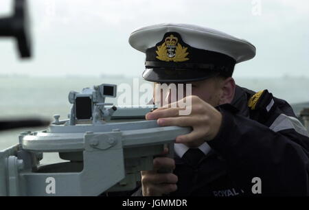 AJAXNETPHOTO. AT SEA, UK TERRITORIAL WATERS. - BEARING - ROYAL NAVAL OFFICER ON A FRIGATE TAKES A BEARING USING A GYRO REPEATER COMPASS. PHOTO:JONATHAN EASTLAND/AJAX REF:D142610 889 Stock Photo