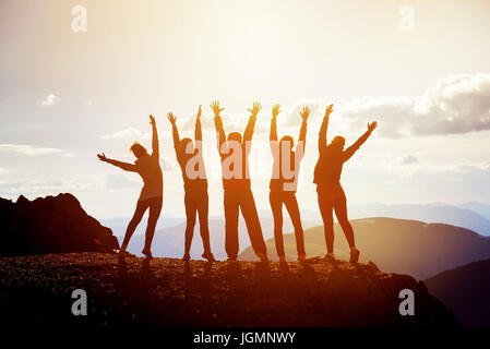 Group of happy people with arms raised representing diverse professions ...