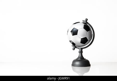 still life image of football world globe on white Stock Photo