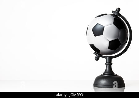 still life image of football world globe on white Stock Photo