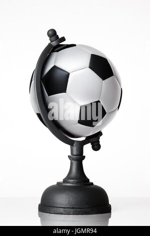 still life image of football world globe on white Stock Photo
