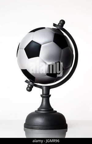 still life image of football world globe on white Stock Photo