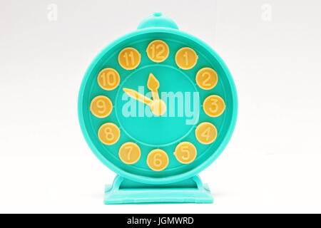 Decorative toy alarm clock on a white background. Stock Photo