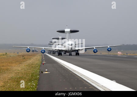 GEILENKIRCHEN, GERMANY - JUL 2, 2017: Row of NATO Boeing E-3 Sentry AWACS radar planes on the runway of Geilenkirchen airbase. Stock Photo