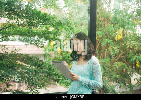 Author, Typewriter, Journalist. Intelligent woman standing on balcony and thinking Stock Photo
