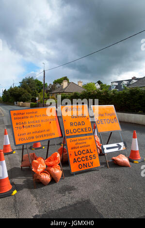 Road blocked detour signs sign signage in English and Gaelic languages. Donegal, Ireland Stock Photo