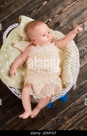 Infant pointing finger. Small child top view. Baby growth and development. Stock Photo