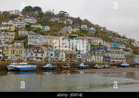 A mixture of different colours and style of houses in West Looe overlook the small fishing fleet in the Looe River, Looe, Cornwall, England, UK Stock Photo