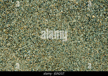 Wet gray sand close-up, wallpaper, background, grains of sand. Stock Photo