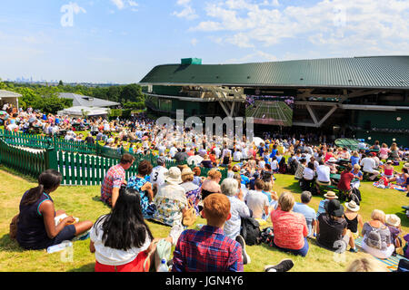 A crowded Aorangi Terrace, known as 'Henman Hill' in hot weather and sunshine, as people watch a match at the Wimbledon Tennis Championships 2017, UK