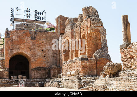 TAORMINA, ITALY - JUNE 29, 2017: ruined walls of Teatro antico di Taormina, ancient Greek Theater (Teatro Greco) in Taormina city. The amphitheater wa Stock Photo