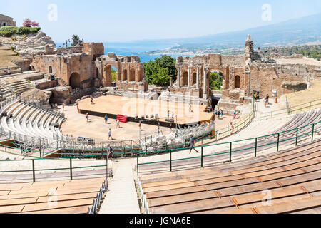 TAORMINA, ITALY - JUNE 29, 2017: people in Teatro antico di Taormina, ancient Greek Theater (Teatro Greco) in Taormina city in summer day. The amphith Stock Photo