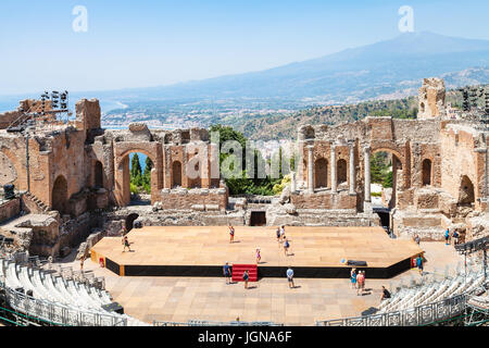 TAORMINA, ITALY - JUNE 29, 2017: people in Teatro antico di Taormina, ancient Greek Theater (Teatro Greco) and view of Etna mount in summer day. The a Stock Photo