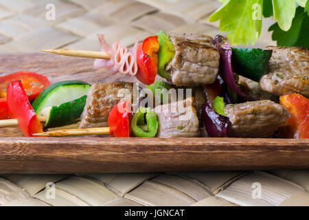Brochettes of meat and vegetables, grilled on the barbecue Stock Photo
