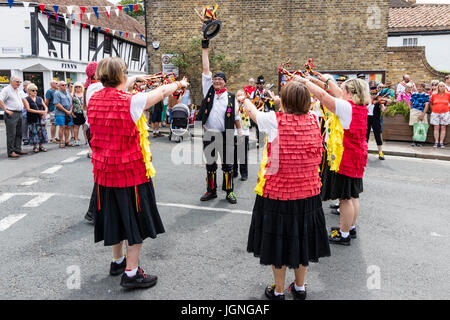 Morris dancers folk dancing in street at the Folk and Ale event, Sandwich. Members of the Kent Korkers and Port Scratchins morris side. Stock Photo