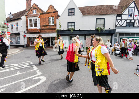 England, Sandwich folk and ale festival. Kent Korkers & Port Scratchin's Morris side dancing while holding wooden poles, in the streets of the medieval town. Stock Photo