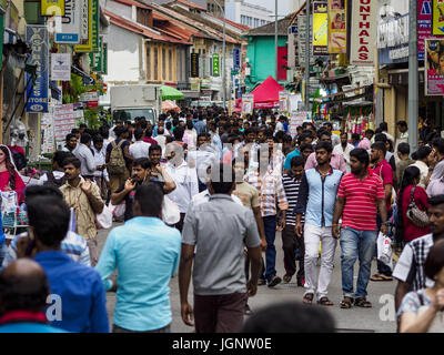 July 9, 2017 - Singapore, Singapore - Guest workers from the Indian sub-continent on Dunlop Street in Singapore's ''Little India'' neighborhood. There are hundreds of thousands of guest workers from the Indian sub-continent in Singapore. Most work 5 Â½ to six days per week. On Sundays, the normal day off, they come into Singapore's ''Little India'' neighborhood to eat, drink, send money home, go to doctors and dentists and socialize. Most of the workers live in dormitory style housing far from central Singapore and Sunday is the only day they have away from their job sites. Most work in blue c Stock Photo